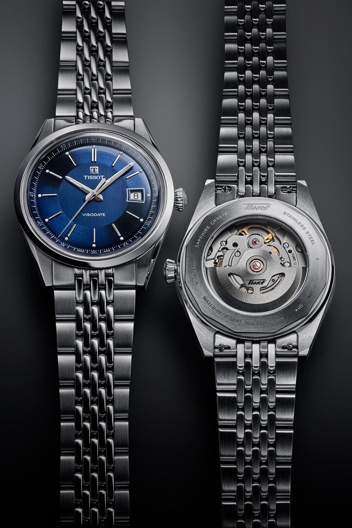 Two Tissot Visodate's laying beside eachother. One showing the dial and the other showcasing the movement through the caseback. 