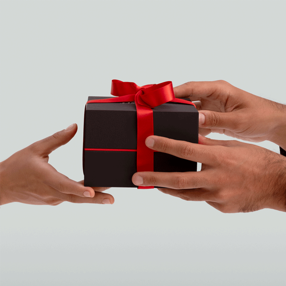 Hands offering a gift box