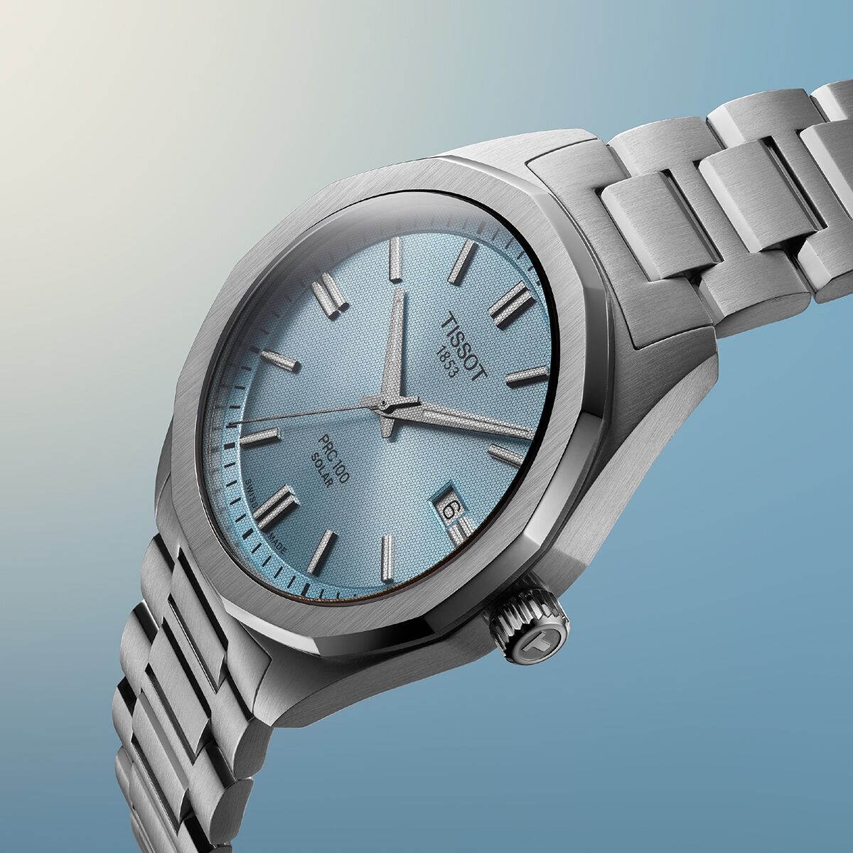 A close-up of the PRC 100 Solar in a silver case with a blue dial