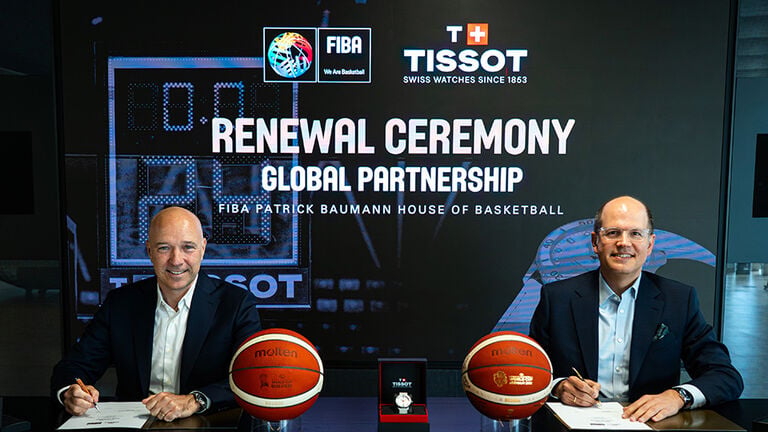 Patrick Baumann and Sylvain Dolla sign an agreement extending their partnership during an official ceremony.