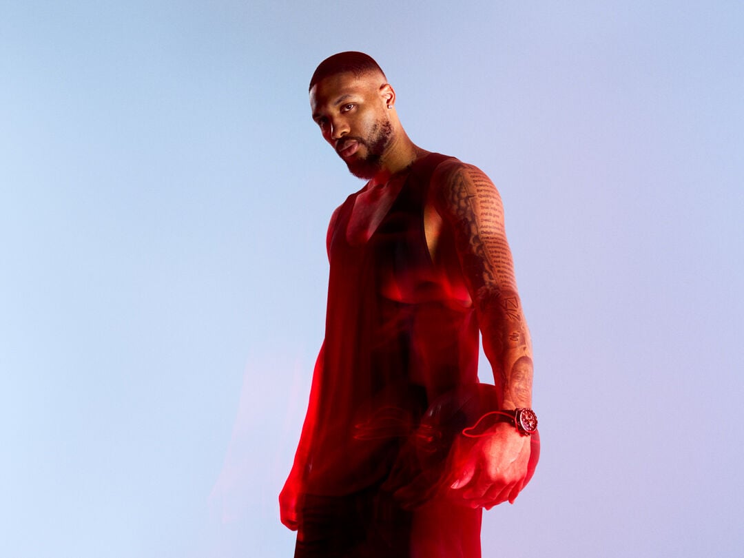 NBA Star Damian Lillard holding a basketball and wearing a Tissot watch