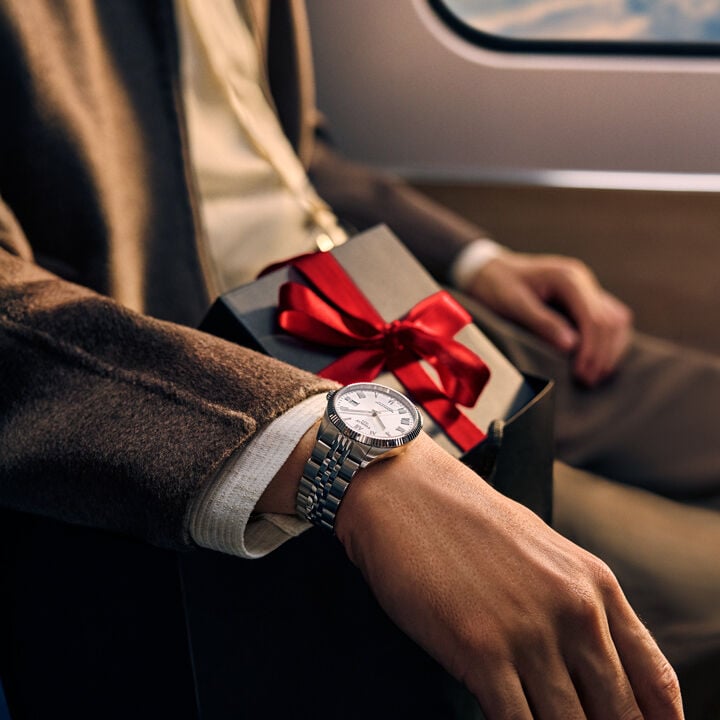 Man in a red car wearing a PR516 watch on his wrist