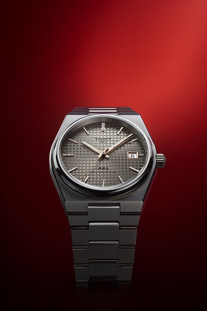 Tissot PRX 38mm against a red background
