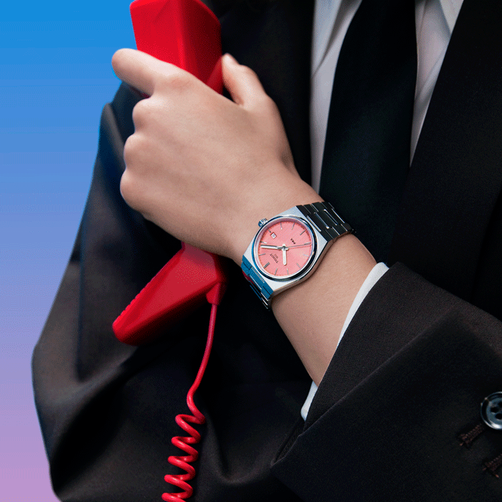 Female model wearing a PRX Graded watch with a pink dial