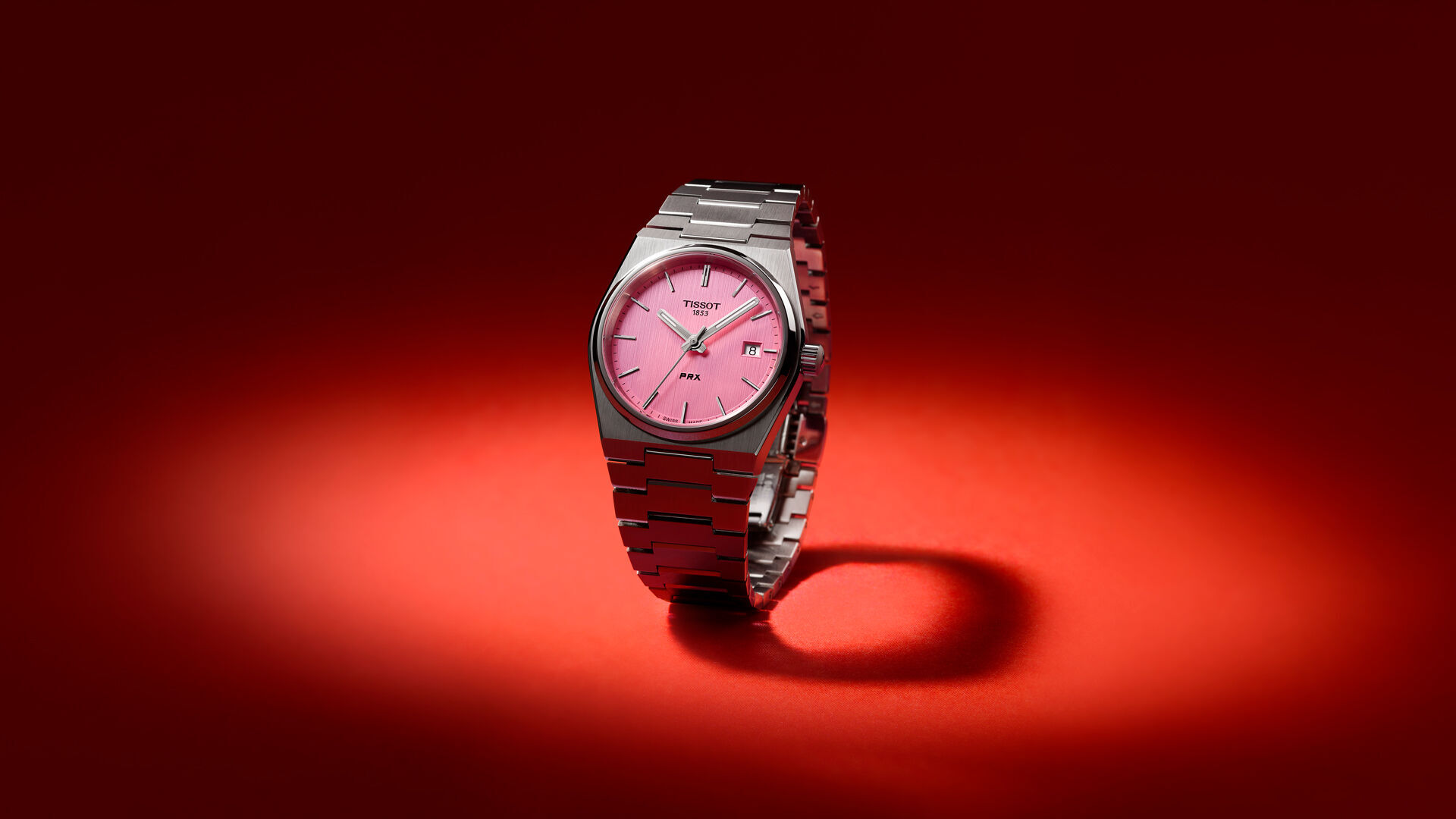 Pink dial Tissot watch on red background