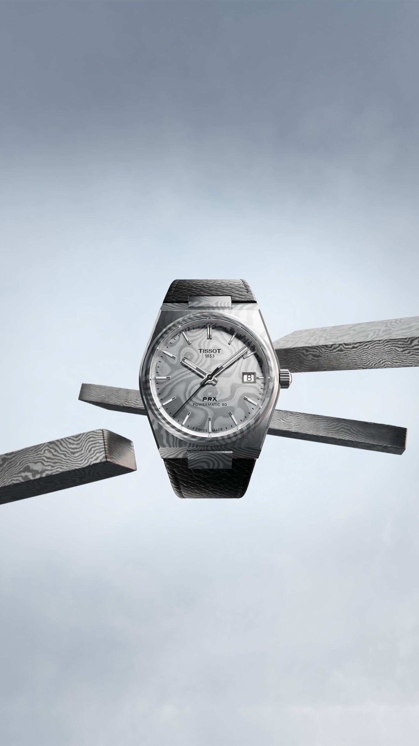 Tissot PRX 38mm against a sky grey background