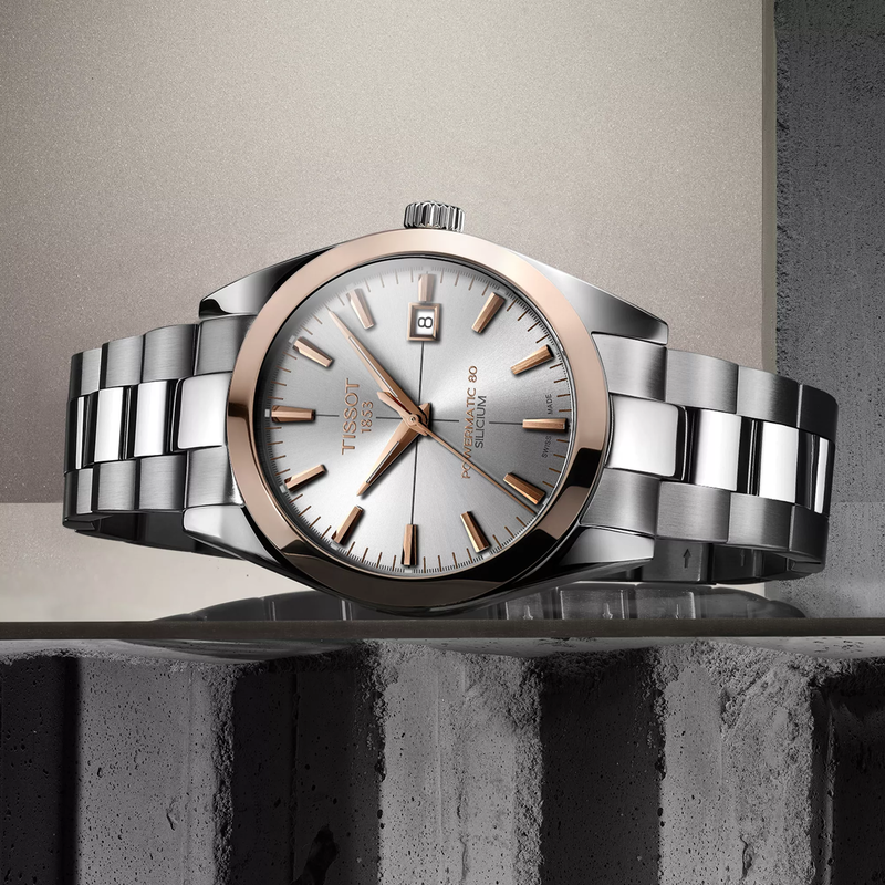 Tissot Gentleman Gold bezel 40mm watch on a colored background