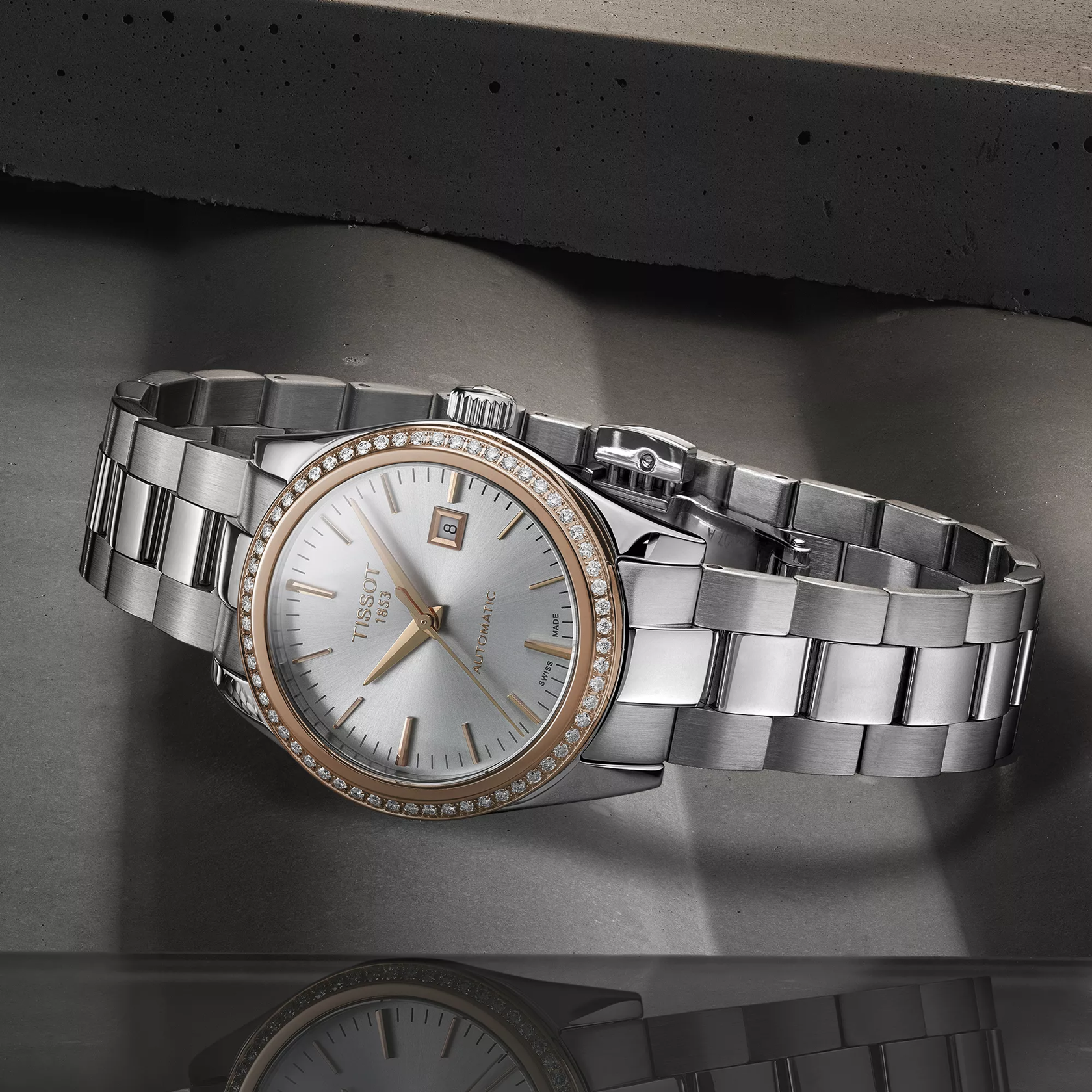Tissot T-My Lady Gold 29mm watch on a colored background