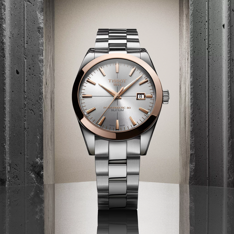 Tissot Gentleman Gold bezel 40mm watch on a colored background