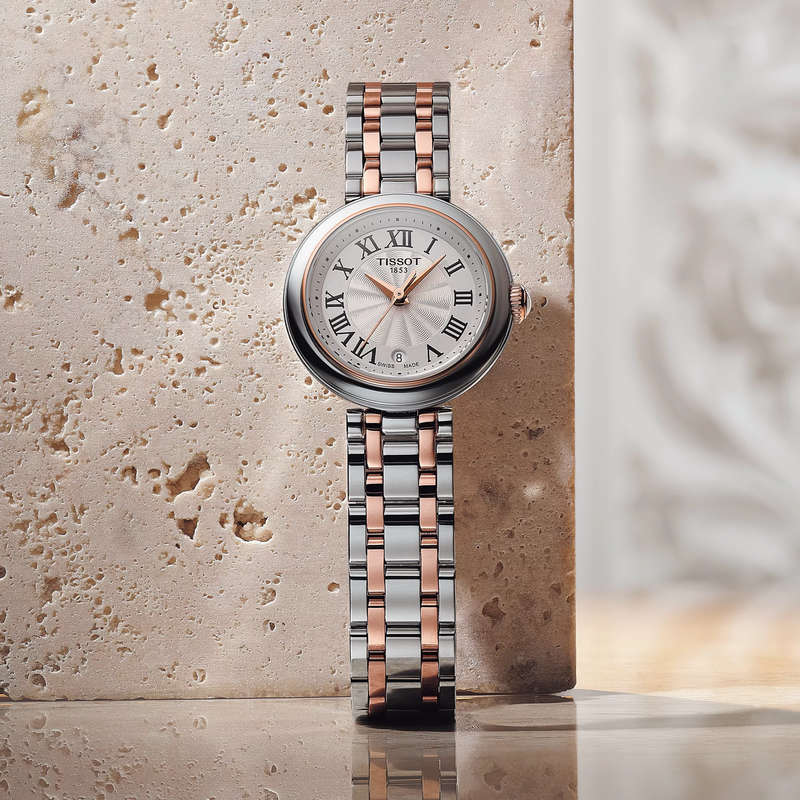 Tissot Bellissima 26mm watch on a colored background