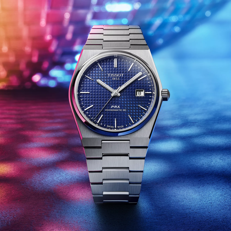 Tissot PRX 40mm watch on a colored background