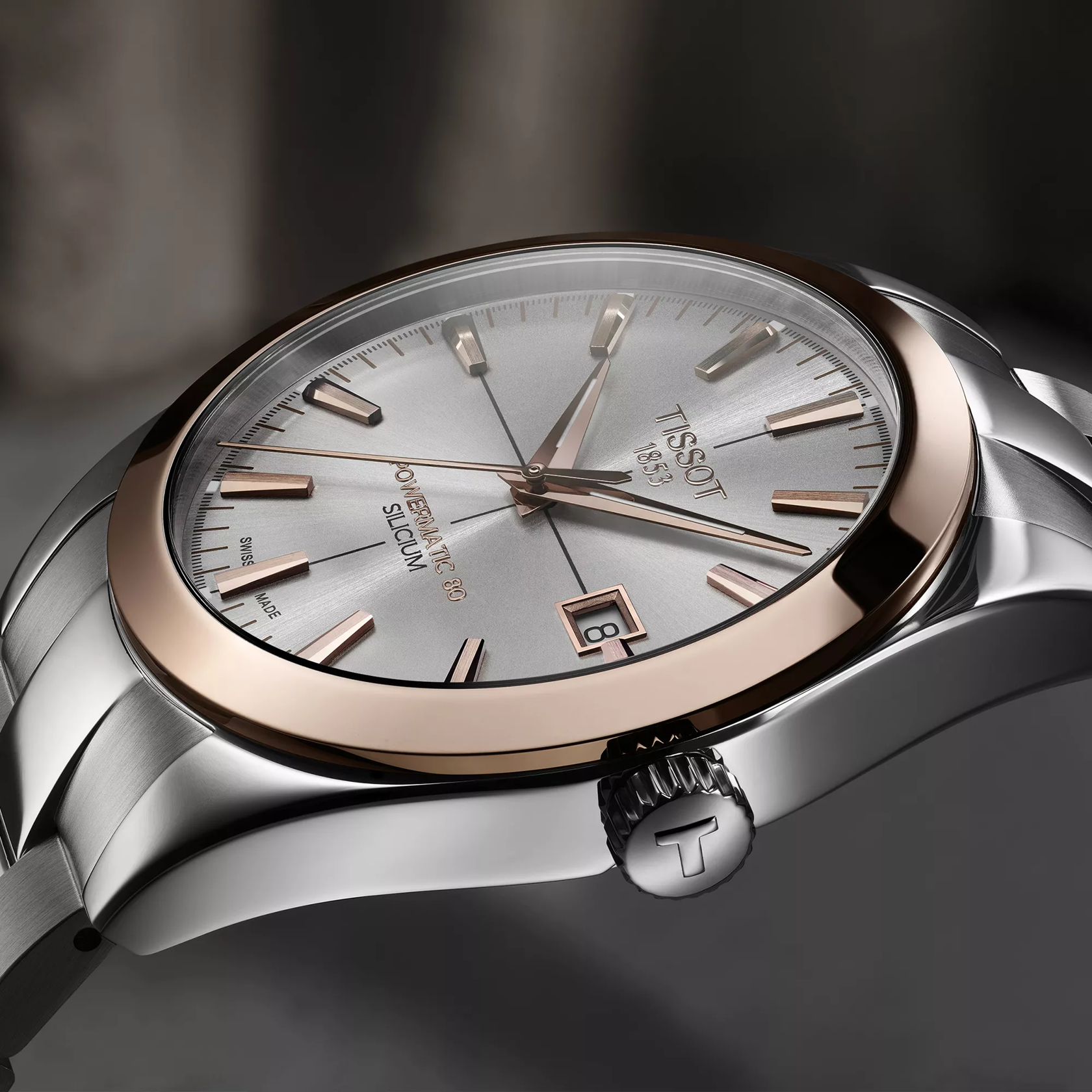 Tissot Gentleman Gold bezel 40mm watch on a colored background