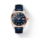 그림자가 있는 티쏘 젠틀맨 파워매틱 80 실리시움 솔리드 18K 골드 베젤 시계의 전면 보기