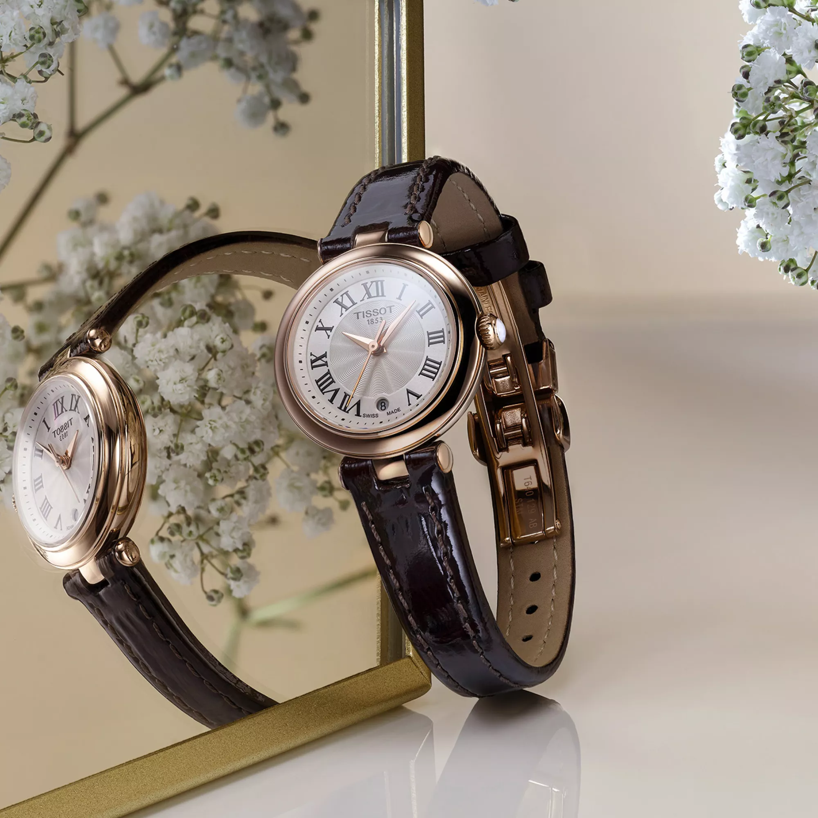 Tissot Bellissima 26mm watch on a coloured background