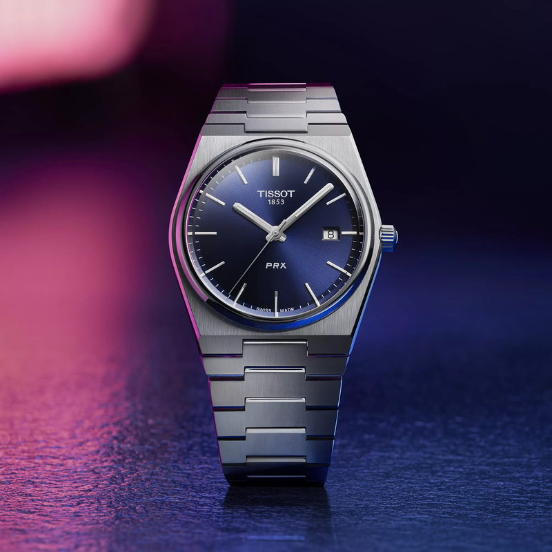Tissot PRX 40mm horloge op een gekleurde achtergrond