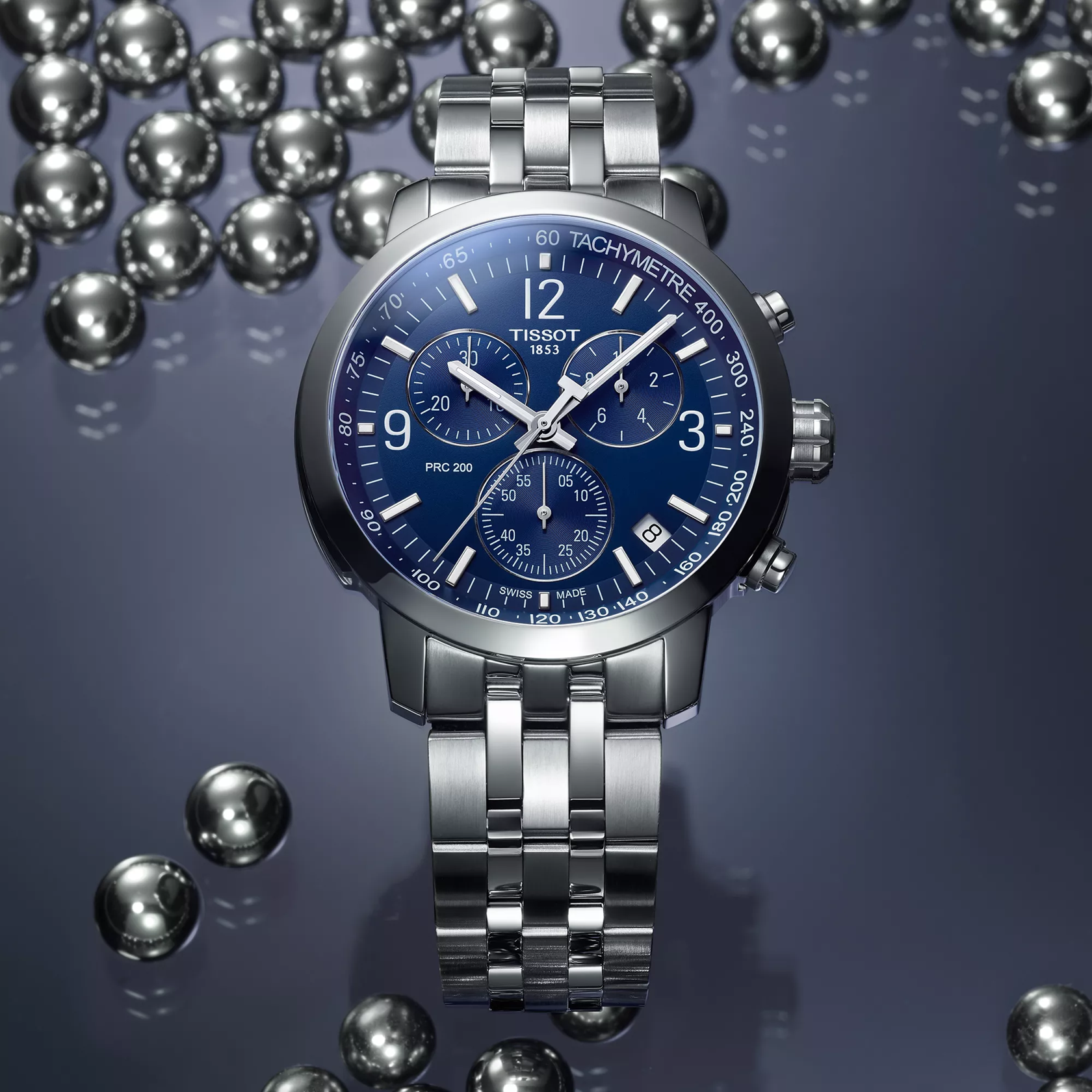 Tissot PRC 200 43mm watch on a colored background