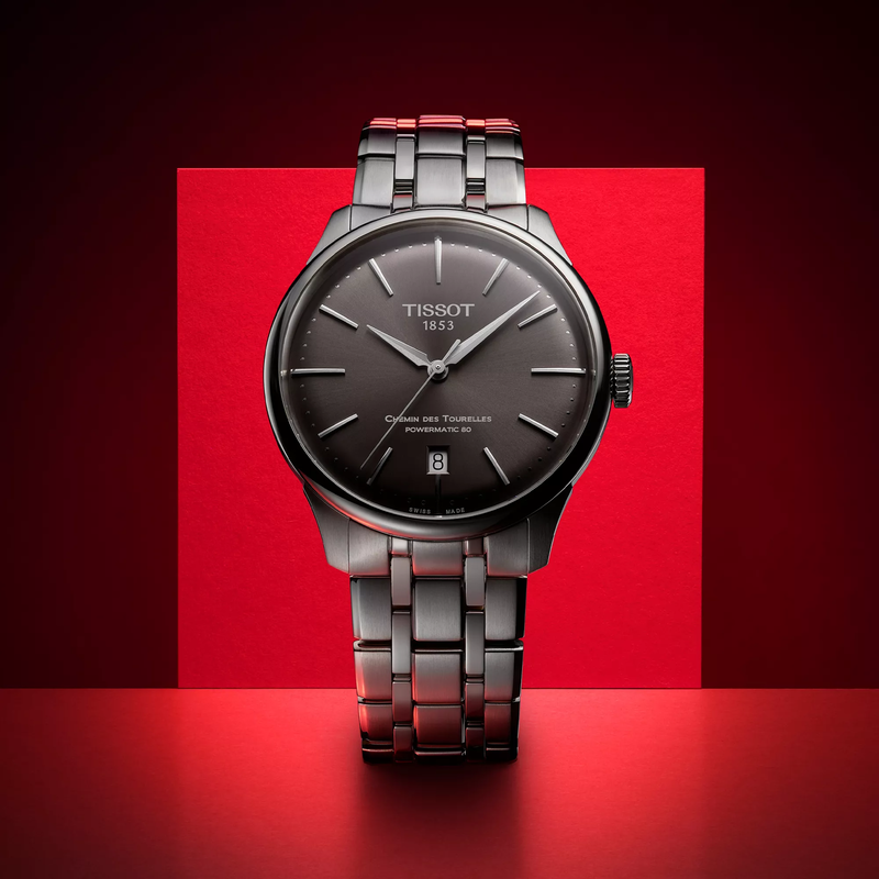 Tissot Chemin des Tourelles Powermatic 80 39 mm watch on a colored background