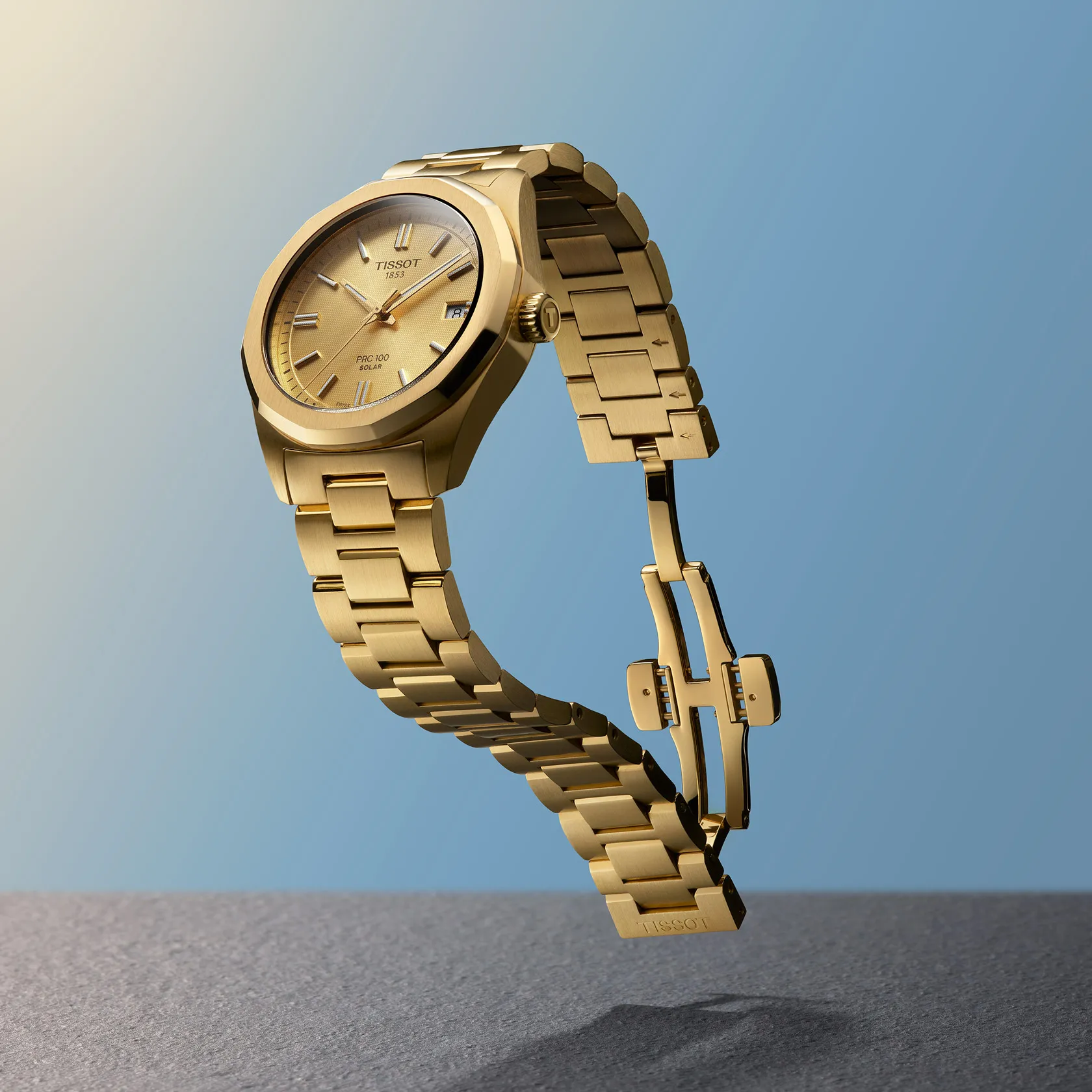 Tissot PRC 100 Solar 34mm watch on a colored background