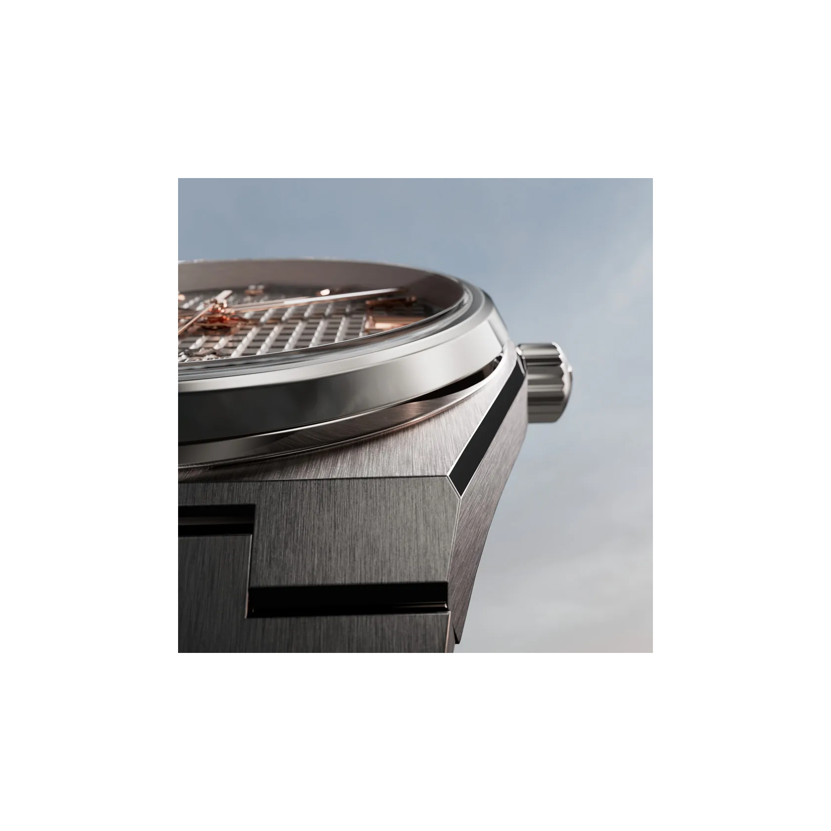 Tissot PRX Titanium 38mm watch on a colored background