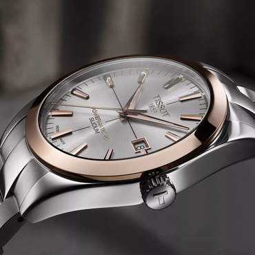 Tissot Gentleman Gold bezel 40mm watch on a colored background