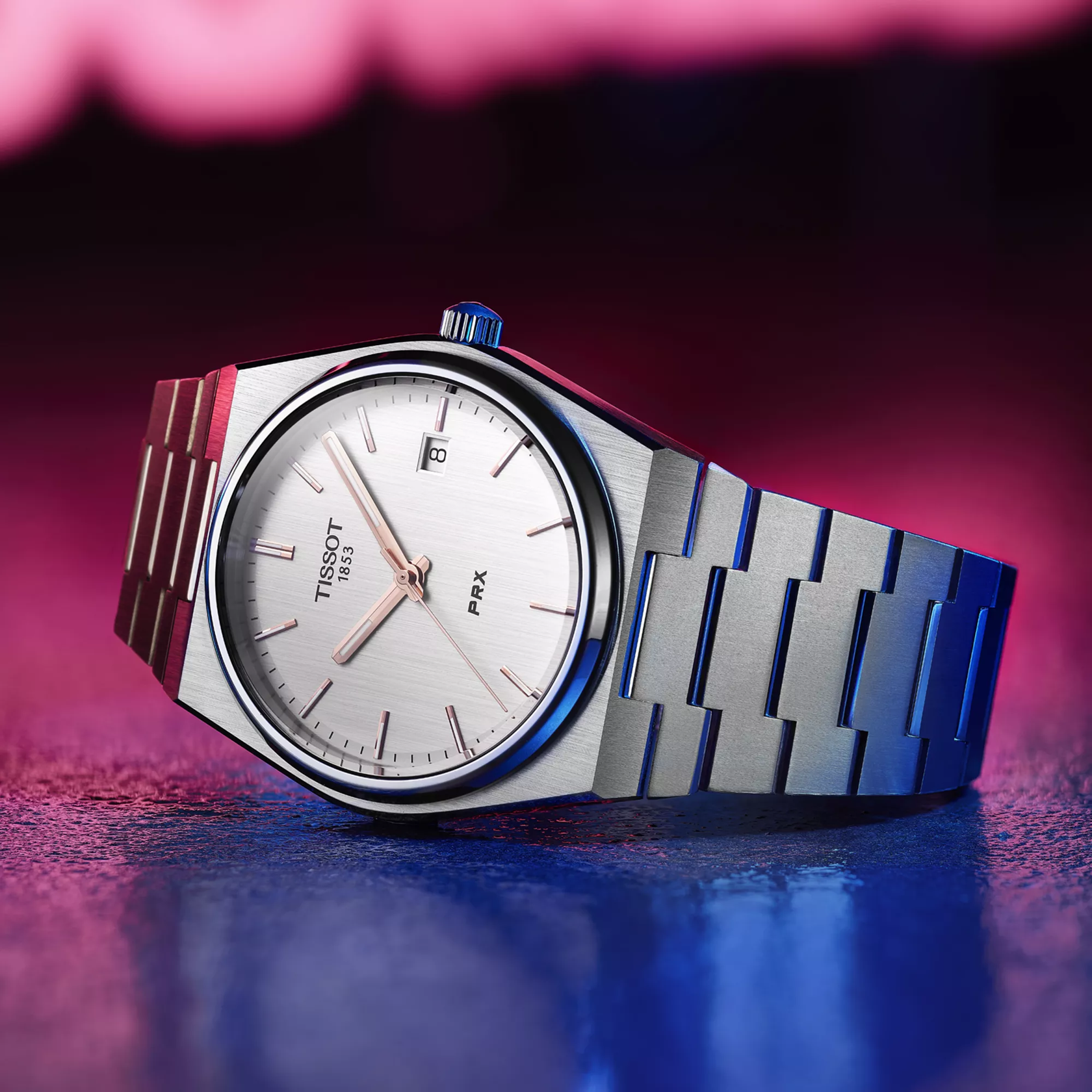 Tissot PRX 40mm watch on a coloured background