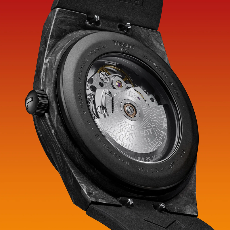 Tissot PRX Carbon 40.5mm watch on a colored background