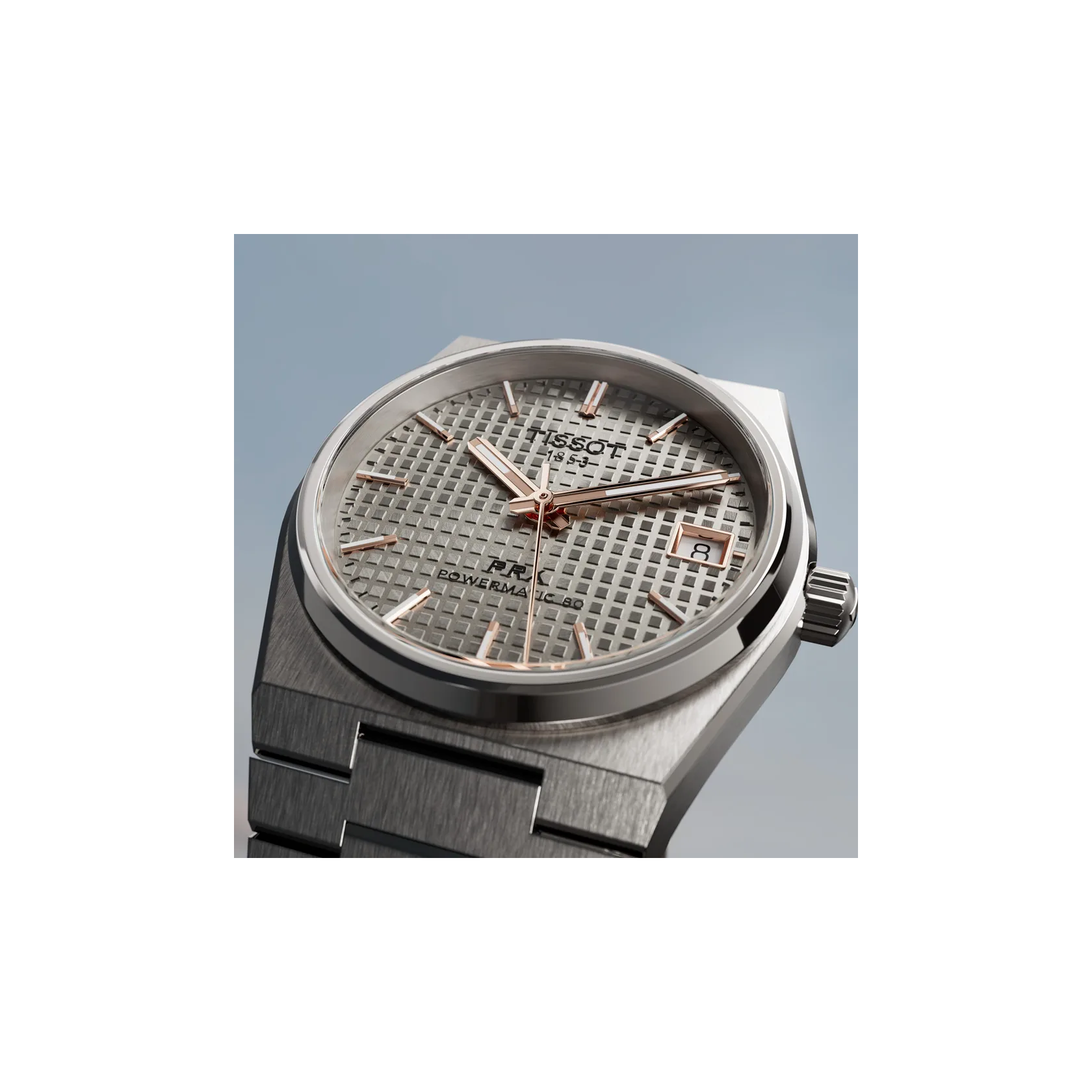 Tissot PRX Titanium 38mm watch on a colored background