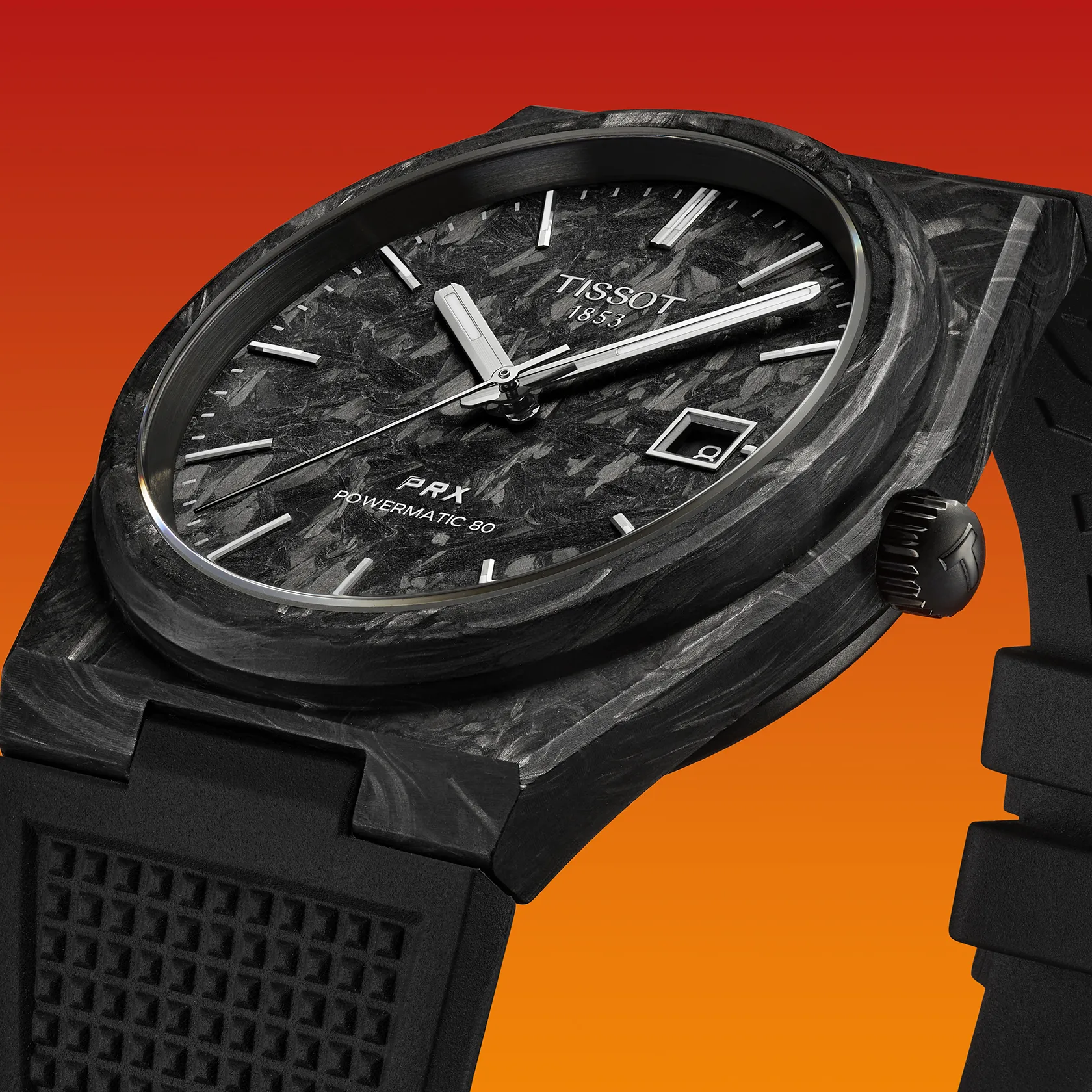 Tissot PRX Carbon 40.5mm watch on a colored background