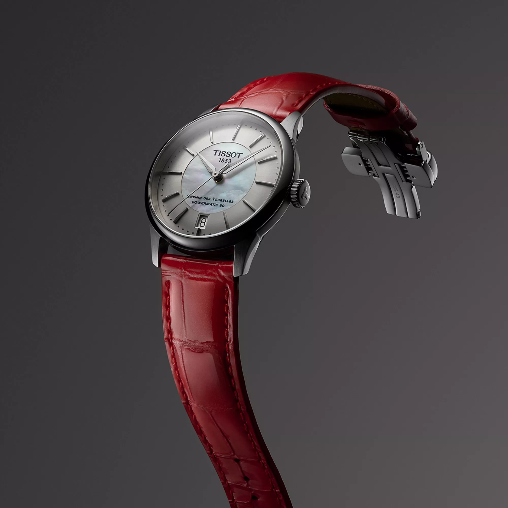 Tissot Chemin des Tourelles Powermatic 80 34 mm reloj en un fondo de color