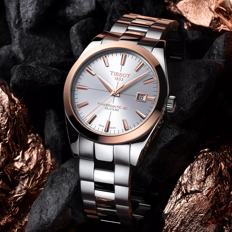 Tissot Gentleman Gold bezel 40mm watch on a colored background