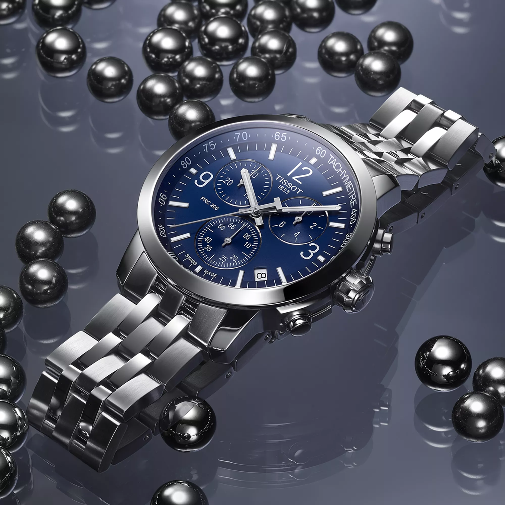Tissot PRC 200 43mm watch on a colored background