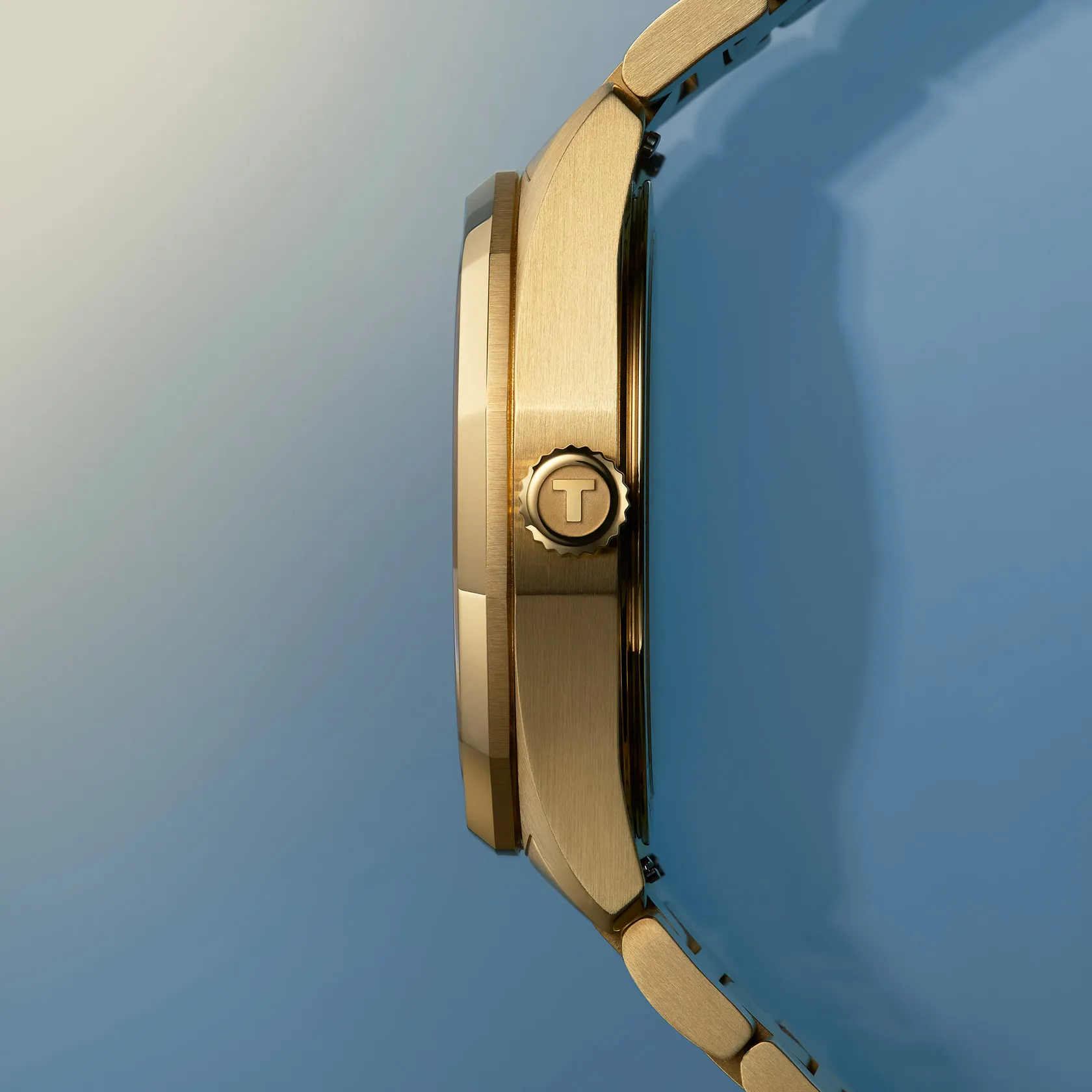 Tissot PRC 100 Solar 34mm watch on a colored background