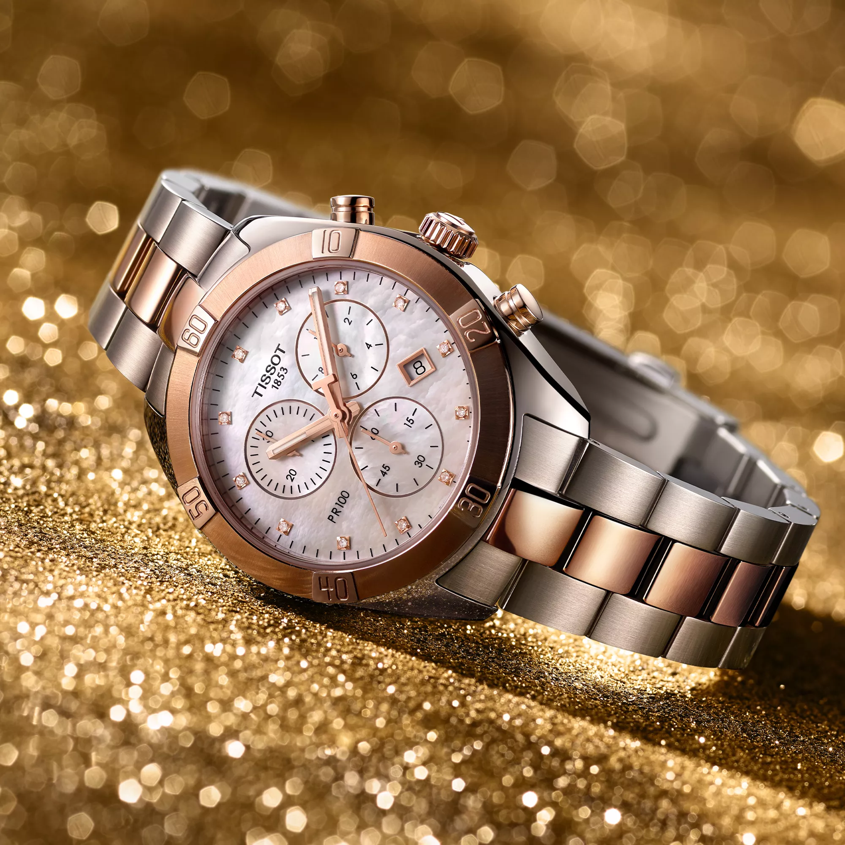 Tissot PR 100 Sport Chic 38mm watch on a colored background