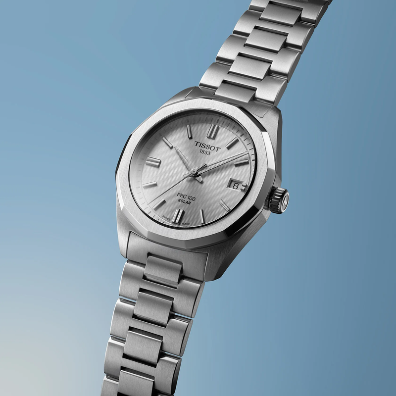 Tissot PRC 100 Solar 34mm watch on a colored background