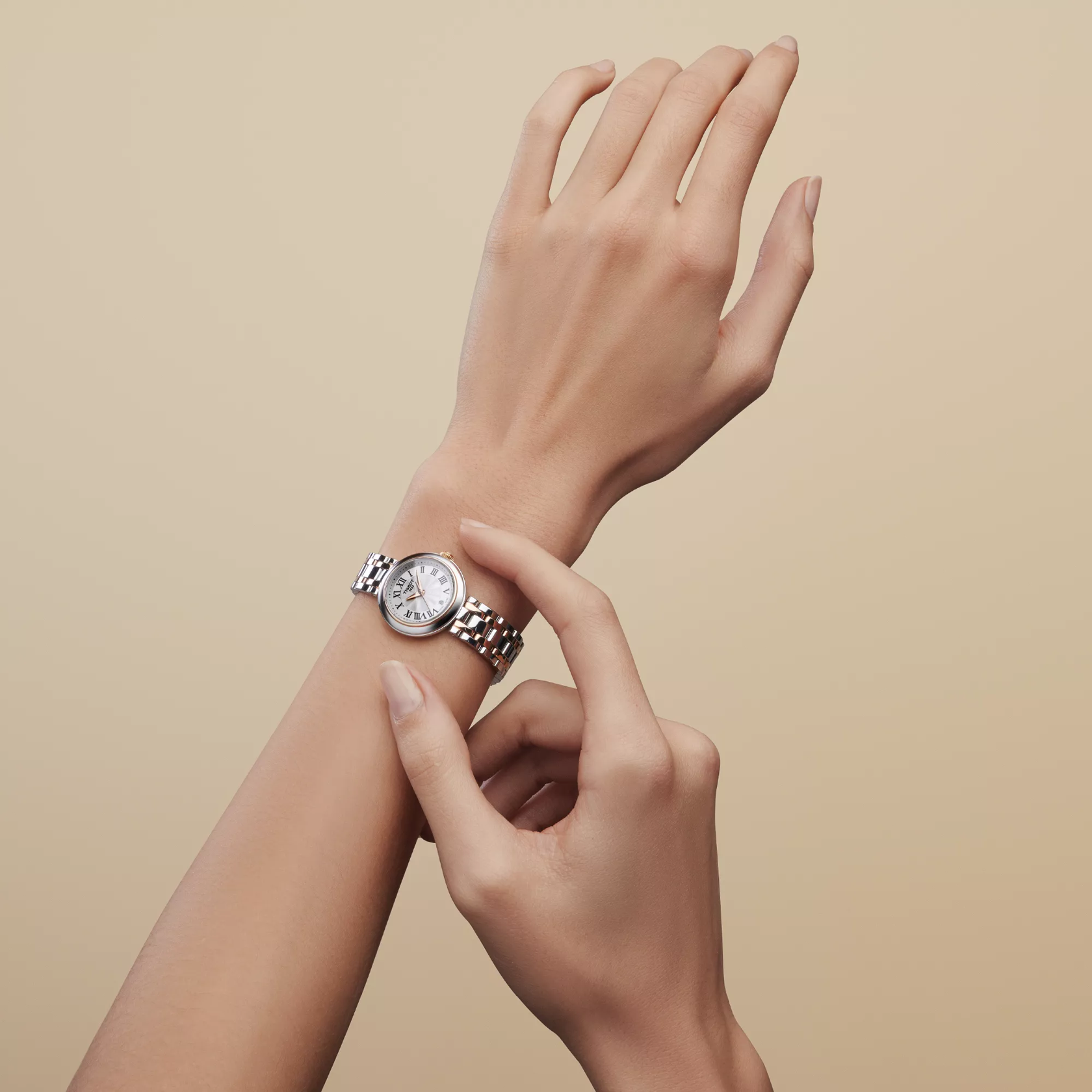 Tissot Bellissima 26mm watch on a colored background