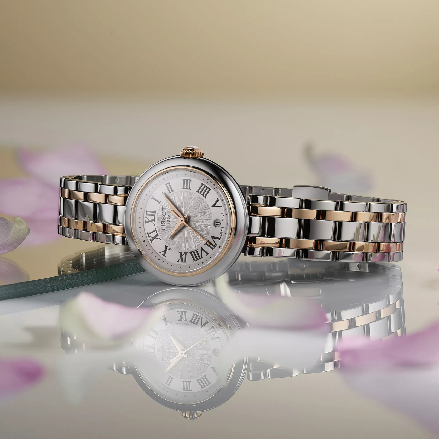Tissot Bellissima 26mm watch on a colored background