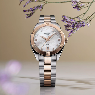 Tissot PR 100 Sport Chic 36mm watch on a colored background