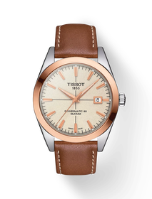 그림자가 있는 티쏘 젠틀맨 파워매틱 80 실리시움 솔리드 18K 골드 베젤 시계의 전면 보기