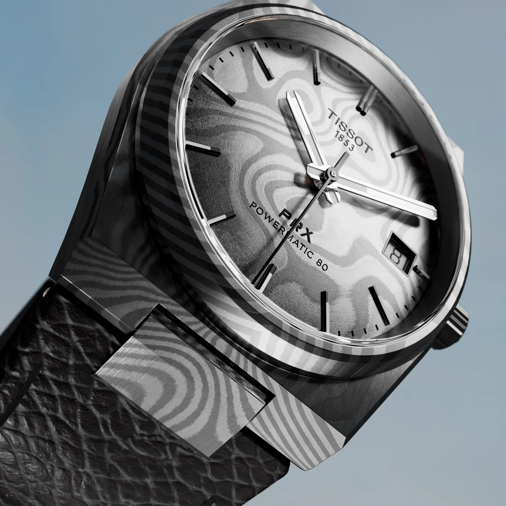 Tissot PRX Damascus Steel 38mm watch on a colored background