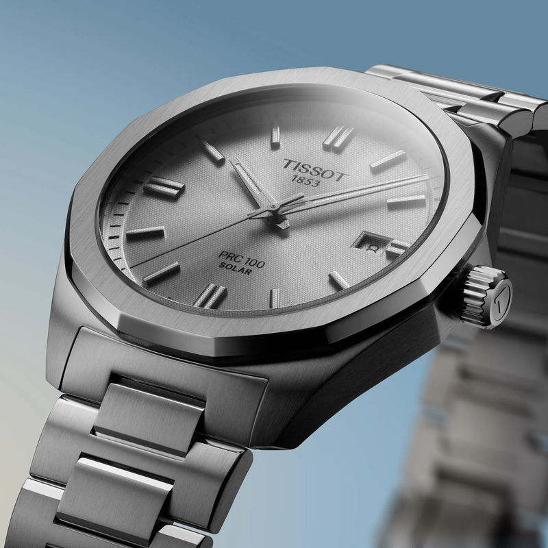 Tissot PRC 100 Solar 39mm watch on a colored background