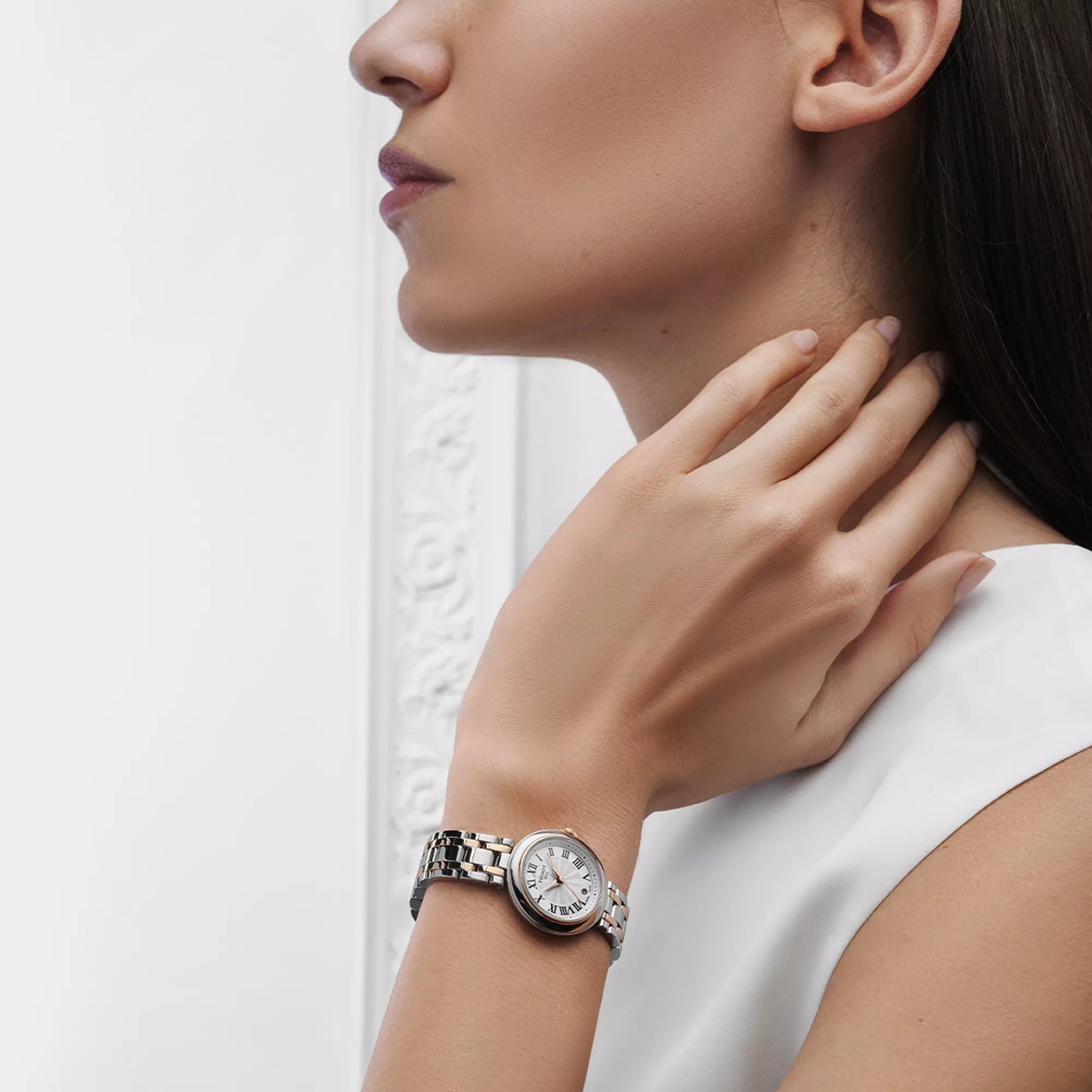 Tissot Bellissima 26mm watch on a colored background