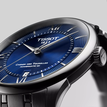 Tissot Chemin des Tourelles Powermatic 80 39 mm watch on a colored background