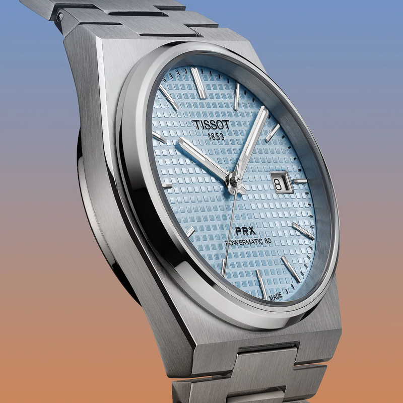 Tissot PRX 35mm watch on a colored background