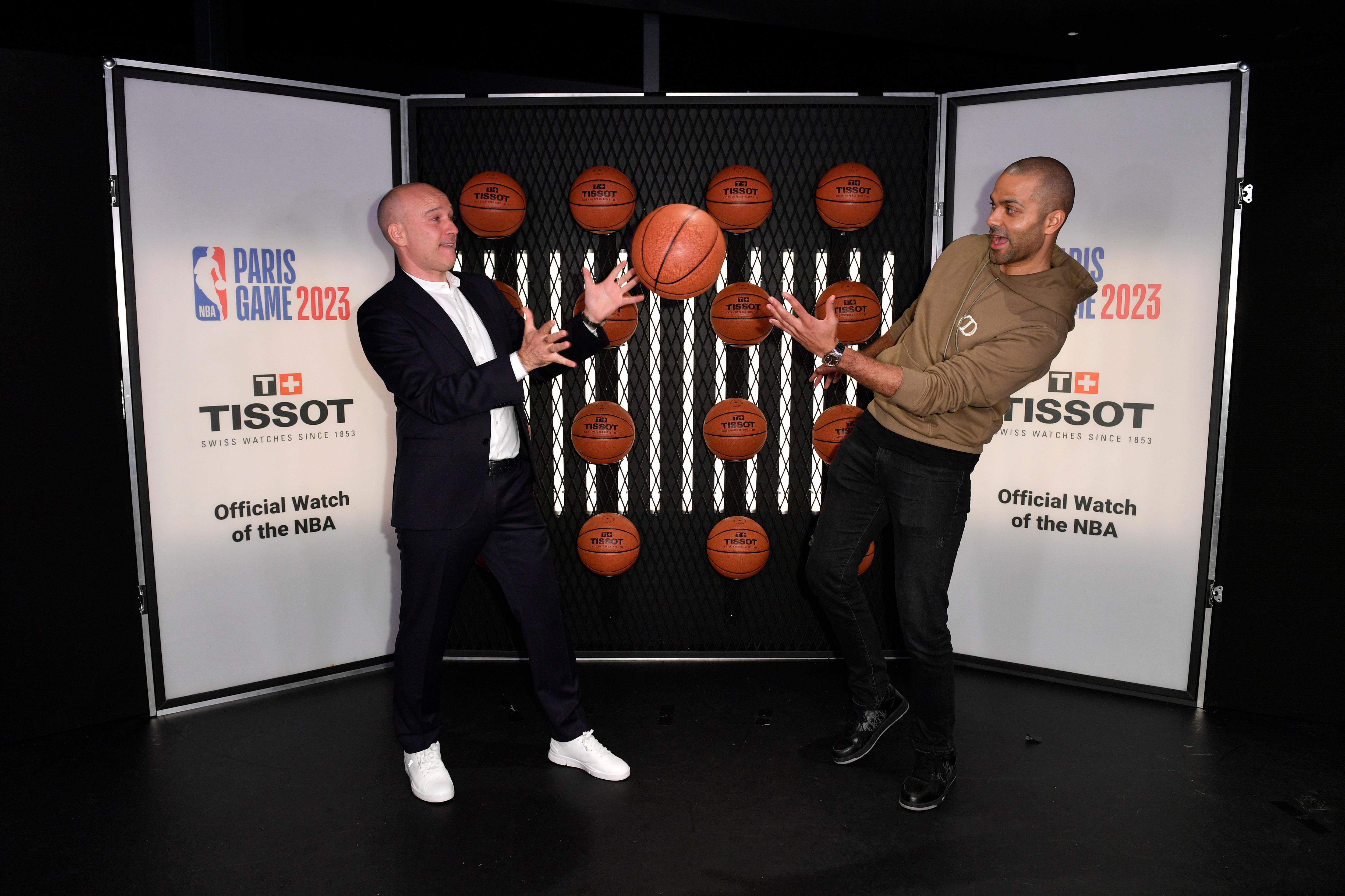 Tony Parker and Sylvain Dolla pass a basketball to each other at the Paris Game 2023