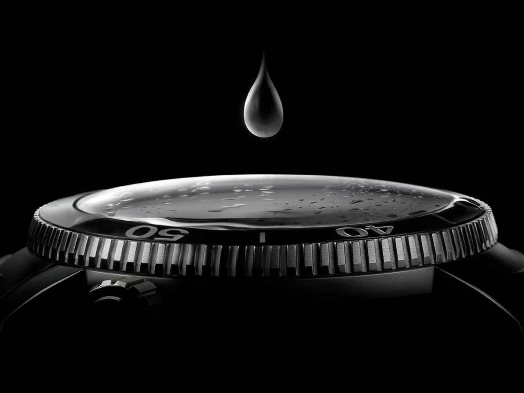 Drop of water falling on a Tissot watch to illustrate Tissot watches' strong water resistance