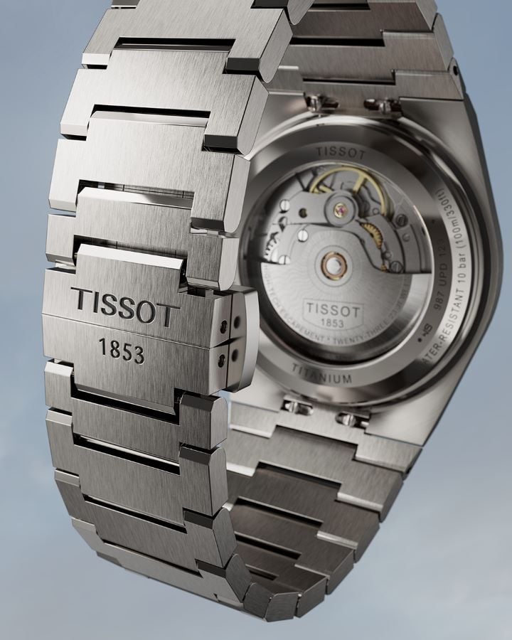 Close-up of the back of the Tissot PRX 38mm Titan watch case showing the Powermatic 80 movement