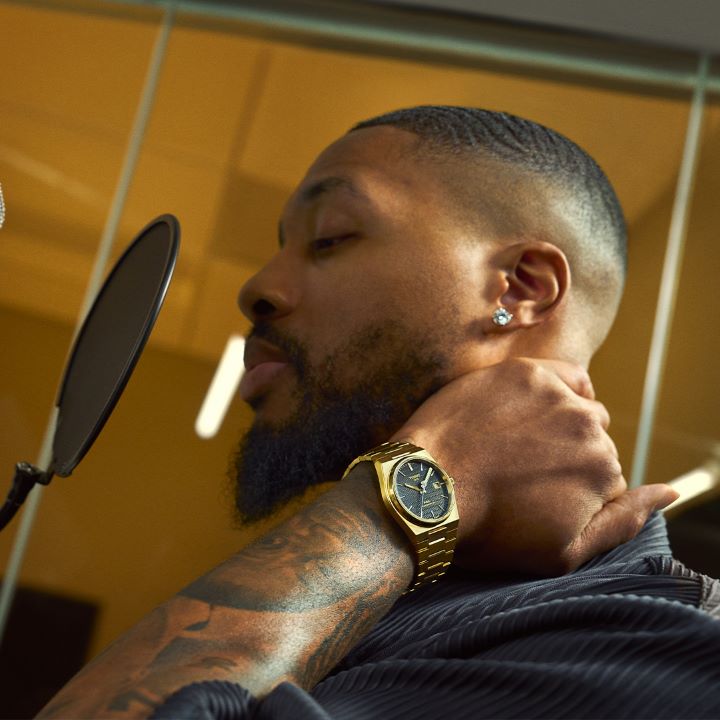 Damian Lillard in a recording studio, with the Tissot PRX Damian Lillard Special Edition on his wrist