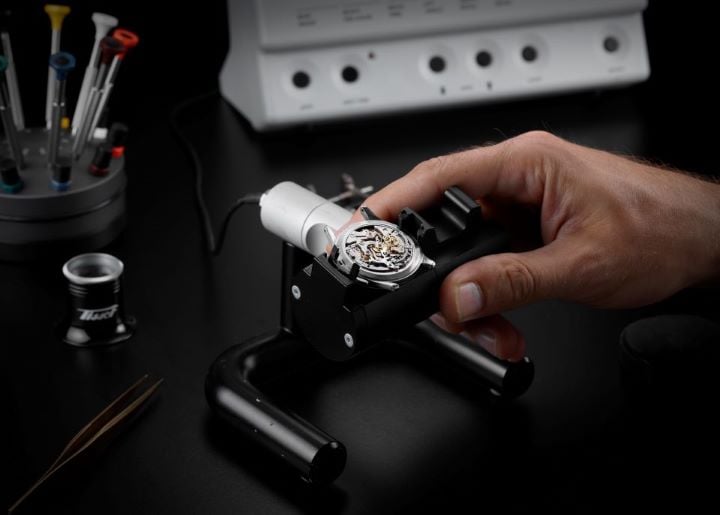 Open Tissot watch showcasing its movement.