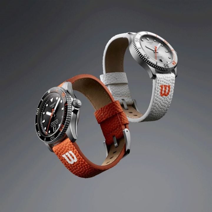 The Tissot Seastar Wilson WNBA automatic watch, with orange strap and black dial, and its quartz version with white dial and strap, floating on a black background.