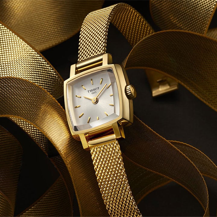 Gold PVD Tissot Lovely, surrounded by multiple steel Lovely straps, also in gold PVD